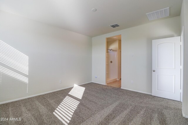 spare room featuring light colored carpet