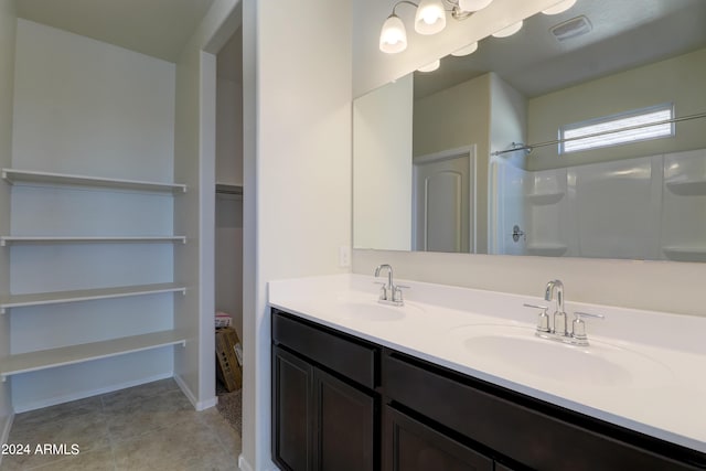 bathroom with a shower and vanity