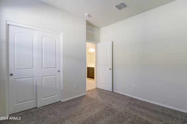 unfurnished bedroom with a closet and carpet flooring