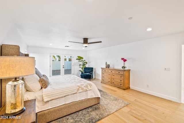 bedroom featuring french doors, light wood-type flooring, and ceiling fan