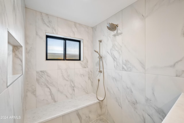 bathroom with a tile shower