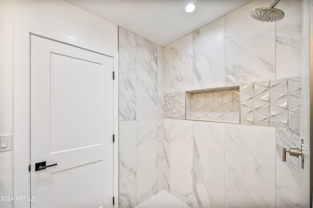 bathroom with a tile shower