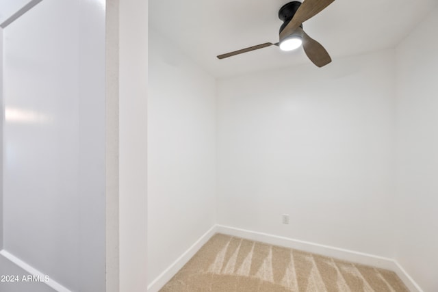 empty room with ceiling fan and carpet