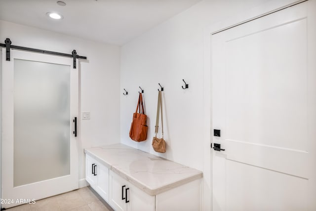 mudroom featuring light tile patterned floors and a barn door