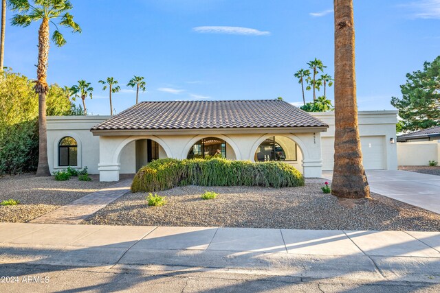 mediterranean / spanish-style house featuring a garage