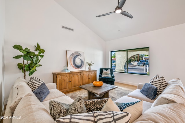 living room featuring high vaulted ceiling, light wood-type flooring, and ceiling fan