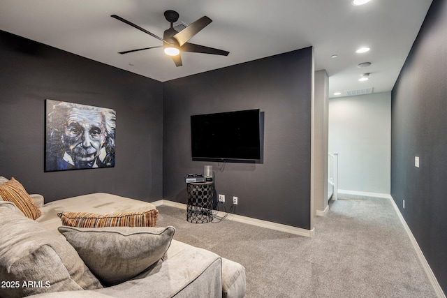 home theater room featuring light colored carpet and ceiling fan