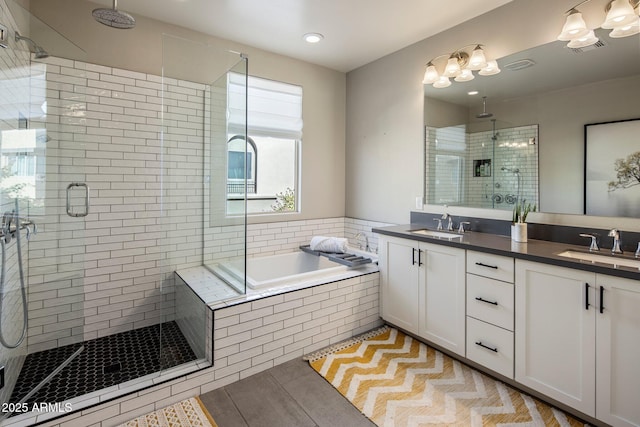 bathroom featuring vanity, tile patterned flooring, and plus walk in shower