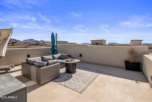 view of patio featuring an outdoor living space with a fire pit