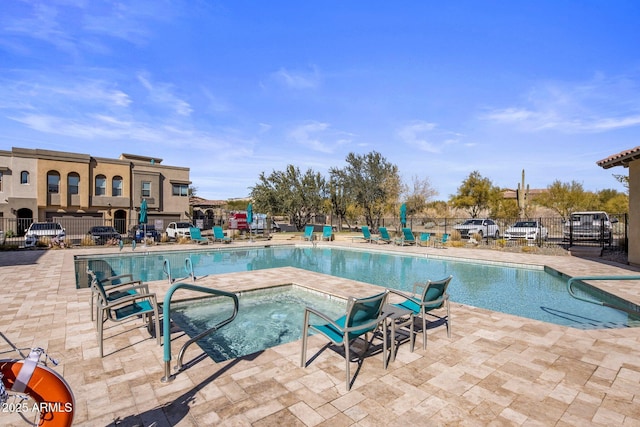 view of swimming pool with a patio and a community hot tub