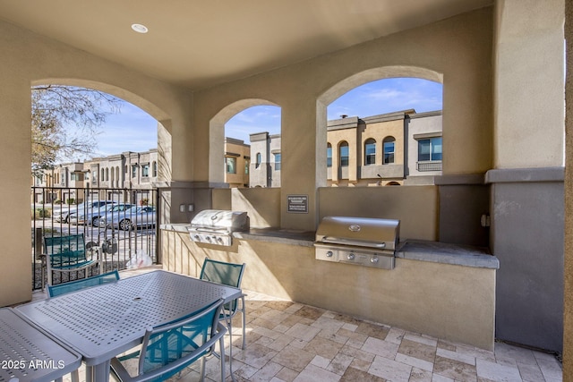 view of patio / terrace featuring an outdoor kitchen and a grill