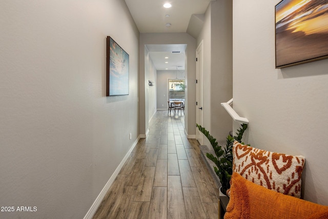 hall with hardwood / wood-style flooring