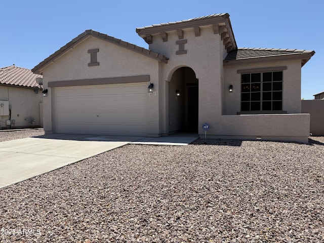 4117 W Allen St, Laveen, AZ 85339 - mediterranean / spanish-style house featuring a tile roof, a garage, concrete driveway, and stucco siding