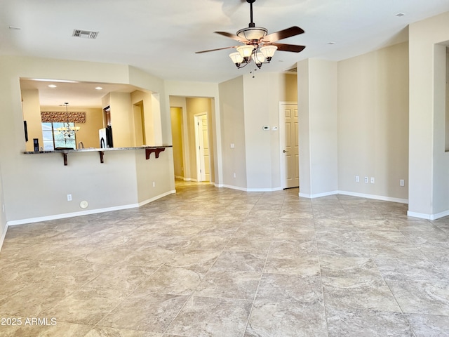 4117 W Allen St, Laveen, AZ 85339 - unfurnished living room with a chandelier, a ceiling fan, and baseboards
