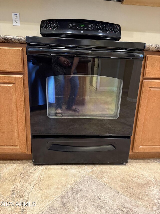 4117 W Allen St, Laveen, AZ 85339 - kitchen view of electric range and brown cabinets
