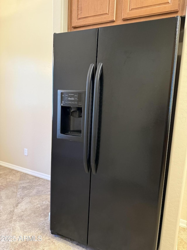 4117 W Allen St, Laveen, AZ 85339 - kitchen view of black fridge with ice dispenser and baseboards