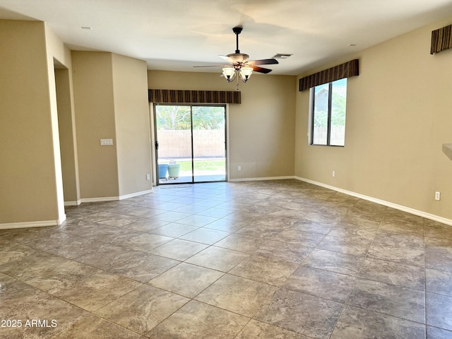 4117 W Allen St, Laveen, AZ 85339 - unfurnished room featuring ceiling fan, baseboards, and stone finish flooring