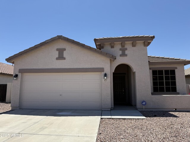 4117 W Allen St, Laveen, AZ 85339 - mediterranean / spanish home with a tile roof, a garage, driveway, and stucco siding