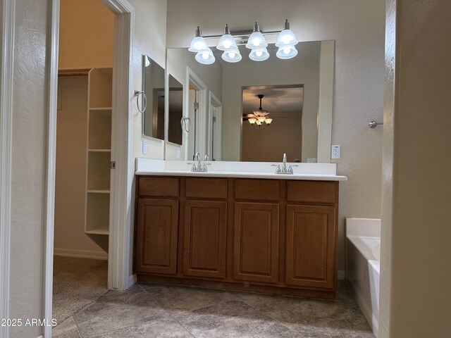 4117 W Allen St, Laveen, AZ 85339 - bathroom featuring a walk in closet, double vanity, a ceiling fan, and a bathtub