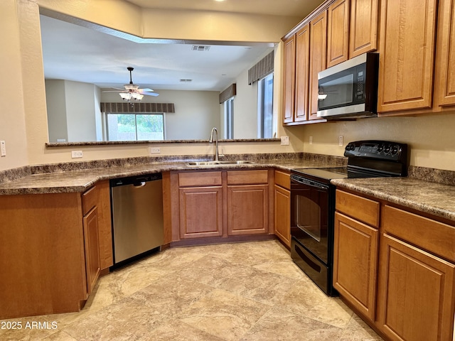 4117 W Allen St, Laveen, AZ 85339 - kitchen with appliances with stainless steel finishes, a sink, dark countertops, and brown cabinets