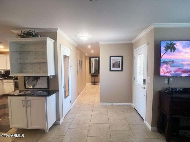 hallway featuring crown molding and light tile patterned floors