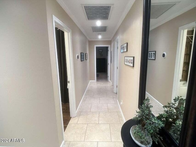 hallway featuring light tile patterned floors and crown molding