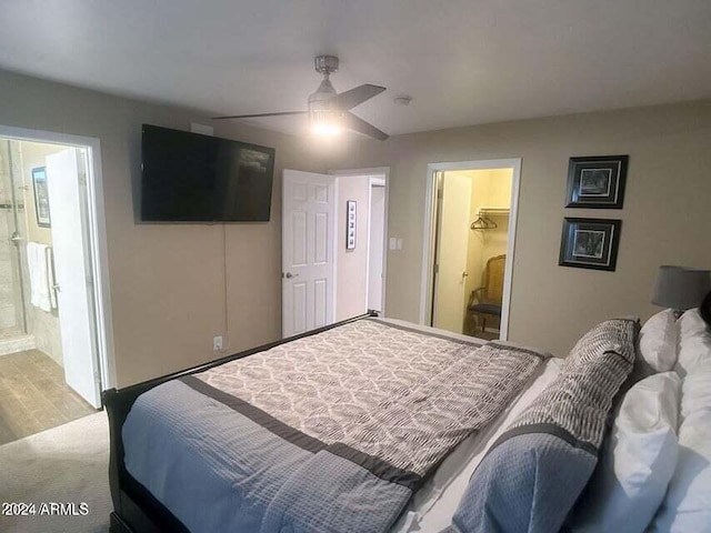 bedroom with connected bathroom, ceiling fan, and carpet floors