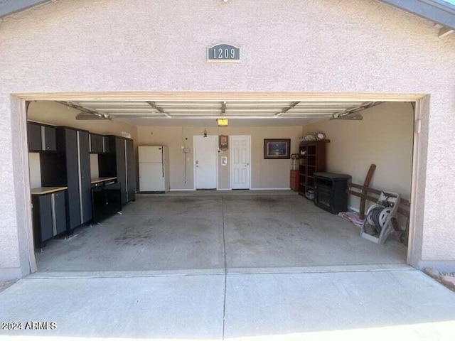 garage featuring white fridge