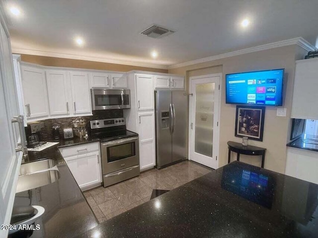 kitchen featuring white cabinetry, sink, crown molding, decorative backsplash, and appliances with stainless steel finishes