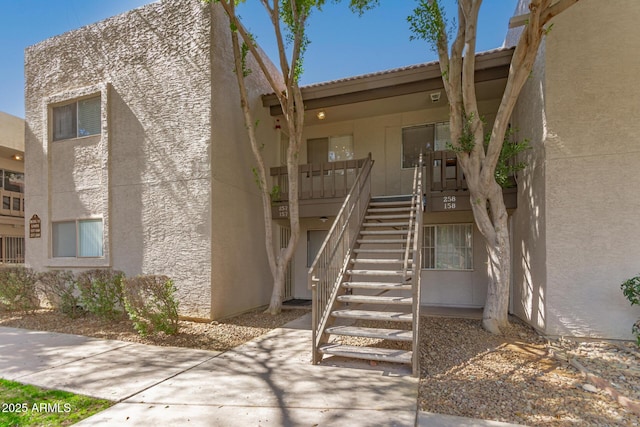 view of property featuring stairway