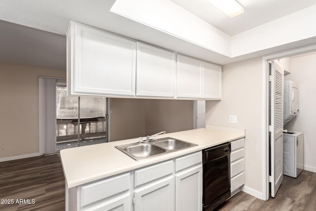 kitchen featuring black dishwasher, a sink, dark wood finished floors, and stacked washer / drying machine