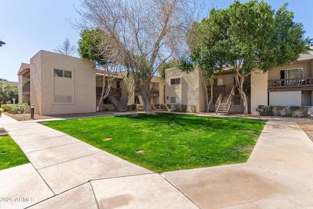 exterior space featuring a lawn and stairway