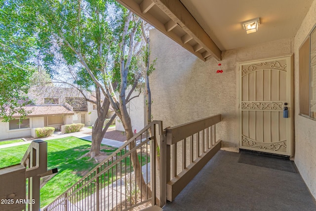 doorway to property featuring stucco siding