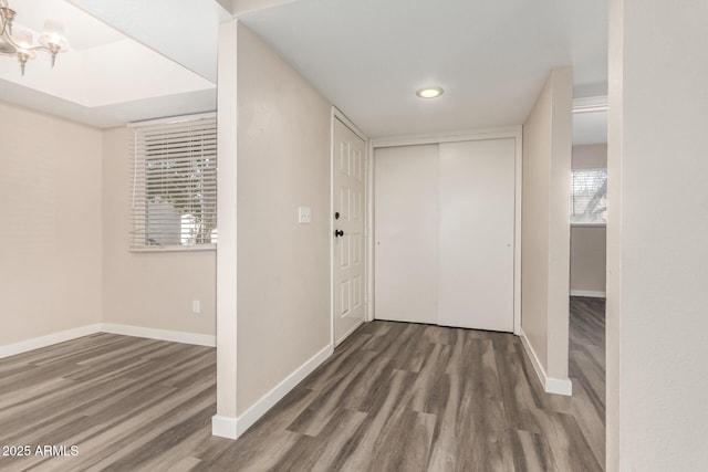 hallway with baseboards and wood finished floors