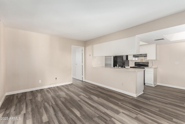 kitchen featuring visible vents, white cabinets, dark wood-style flooring, under cabinet range hood, and black appliances