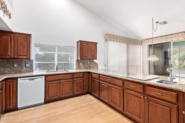 kitchen with dishwasher, pendant lighting, tasteful backsplash, and sink