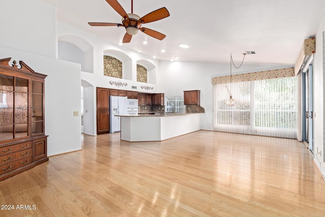 unfurnished living room with ceiling fan, light hardwood / wood-style floors, and lofted ceiling