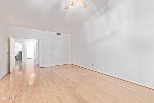 unfurnished room with ceiling fan, vaulted ceiling, and light wood-type flooring