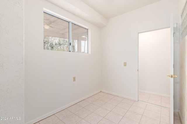 spare room featuring light tile patterned floors