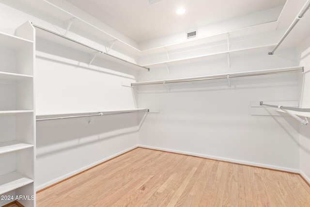 spacious closet with hardwood / wood-style floors