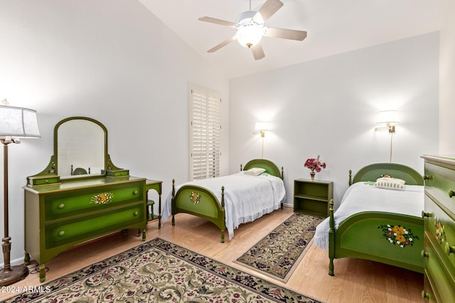 bedroom featuring hardwood / wood-style flooring, ceiling fan, and lofted ceiling