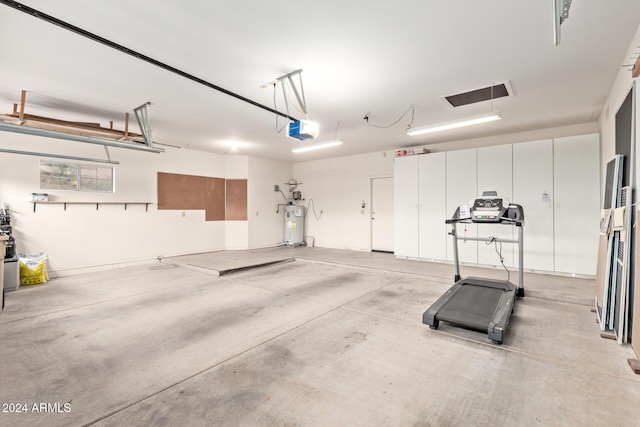 garage featuring electric water heater and a garage door opener