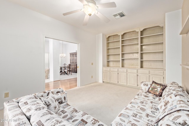 carpeted living room featuring ceiling fan