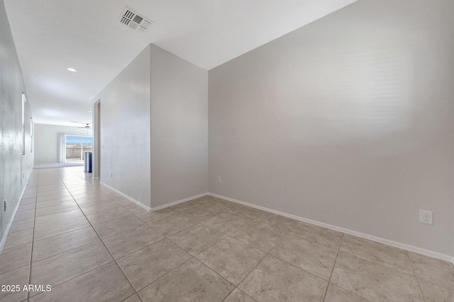 unfurnished room with light tile patterned floors, baseboards, and visible vents