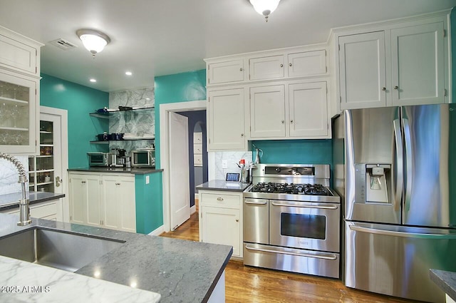 kitchen with white cabinets, sink, and stainless steel appliances