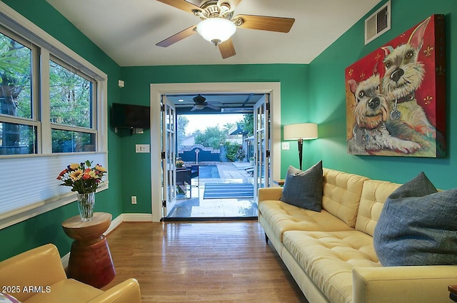 living room with ceiling fan and hardwood / wood-style floors