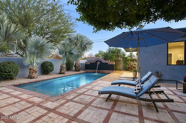 view of pool featuring pool water feature and a patio area