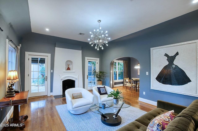 living room with a notable chandelier and hardwood / wood-style floors