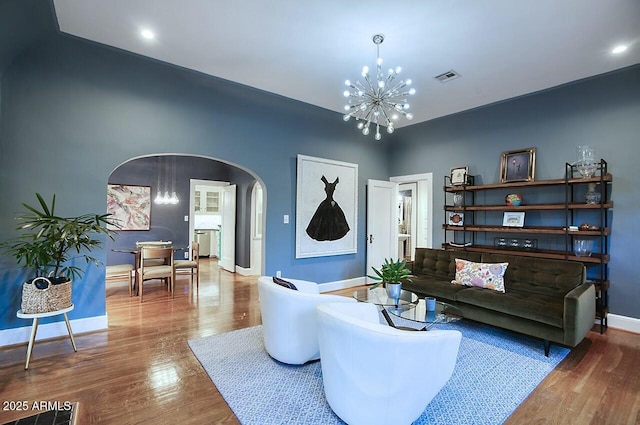 living room featuring hardwood / wood-style floors and an inviting chandelier