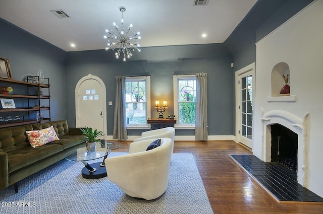 living room featuring a notable chandelier and dark hardwood / wood-style flooring